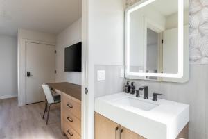 a bathroom with a white sink and a mirror at Adobe Desert in Panguitch