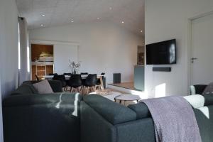 a living room with two couches and a dining room at Billund Guest Lodge in Grindsted