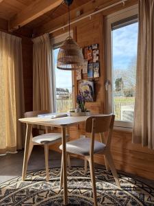 a dining room with a table and chairs and a window at B&B Bed in Burgh in Burgh Haamstede
