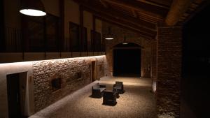 a dark room with two chairs and a table at B&B Cà Breganze in Breganze