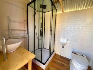 a bathroom with a glass shower and a toilet at Islas Chimu in Puno