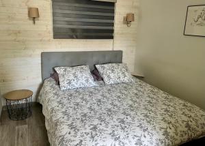 a bed with two pillows on it in a bedroom at Gîte de la Galimondaine in Bouguenais