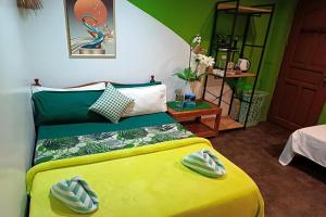 a bedroom with a yellow bed with a yellow blanket at MilVir Tourist Inn El Nido near Beach in El Nido +74 photos