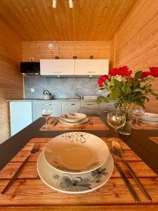 a kitchen with a wooden table with a plate on it at Morska Melodia in Sarbinowo