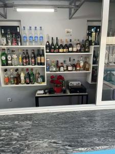 a room with shelves filled with bottles of alcohol at Hotel Pousada Venus in São Filipe
