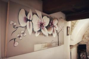 a painting of flowers on a wall at Casa Vacanze Sotto Piazza in Gualdo Tadino