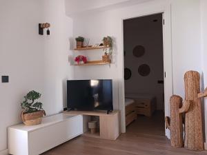 a living room with a flat screen tv on a table at Chalet Las Meninas in Denia