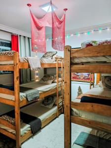 a room with two bunk beds and lights at Vila Urban Hostel ॐ Jardins in São Paulo