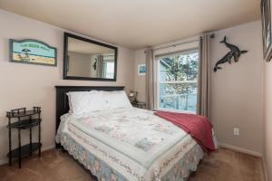 a bedroom with a bed with a mirror and a window at Waldport Beach Haven in Waldport