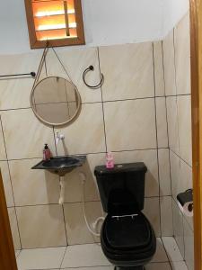 a bathroom with a toilet and a sink at Pousada da vila in Beberibe +4 photos