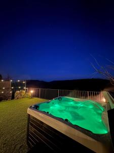 a hot tub in a backyard at night at Cal Bertran in Segura