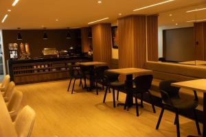 a restaurant with tables and chairs and a counter at Hotel Continental ByHours in Bogotá +31 photos
