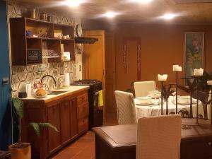 a kitchen with a table and a dining room at Rincon Acogedor in Bogotá +6 photos