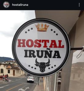 a sign for a hostel in front of a building at Hostal Iruña in Loja