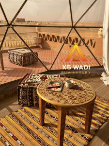 a coffee table in a room with a tent at X5 wadi Rum Luxury in Wadi Rum