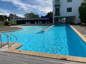 a large blue swimming pool next to a building at The Bay Riveria in Napier