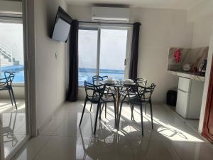 a dining room with a table and chairs in a kitchen at Casa Dorada in Cancún