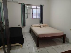 a small bedroom with a bed and a window at Flat, primeiro andar, perto do Chevrolet Hall e Centro de Convenções e in Recife