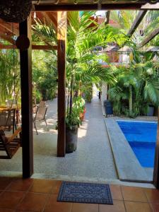 a resort with a pool and palm trees and a patio at Casa de Descanso Lolha Bacalar in Bacalar