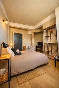 a bedroom with a large bed and a desk at Mulhouse City Loft in Mulhouse