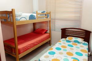 a bedroom with two bunk beds and a bed at Departamento 1 centro de la ciudad in Santo Domingo de los Colorados