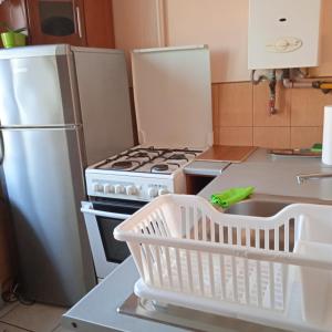 a kitchen with a white stove and a refrigerator at Gościnne Gniazdo in Będzin