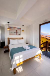 a bedroom with a bed with a view of the ocean at Pousada Tanto Mar in Arraial do Cabo +104 photos