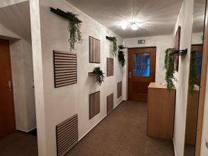 a hallway with plants on the walls of a building at Taverna Unik in Saaldorf