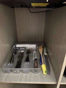 a drawer filled with utensils in a refrigerator at Finca Nona's, Naturaleza y playa in Ciudad Madero