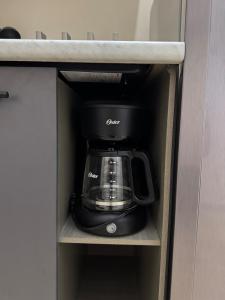a coffeemaker is sitting inside of a kitchen cabinet at Finca Nona's, Naturaleza y playa in Ciudad Madero