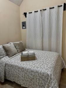 a bedroom with a bed with a white comforter at Finca Nona's, Naturaleza y playa in Ciudad Madero