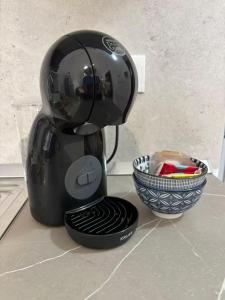 a black mixer sitting on a counter next to a bowl at Piazza Maggiore in Sulmona