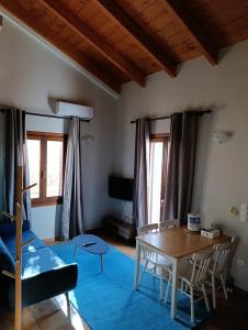 a living room with a table and a dining room at Tesoro of Ithaca in Stavros