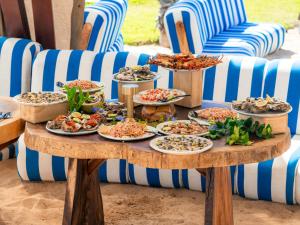 a table full of plates of food on a table at Mayto Astrological Park in Maito