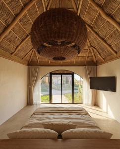 a bedroom with a large bed and a large window at Mayto Astrological Park in Maito