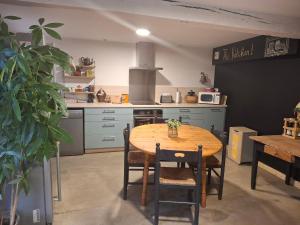 a kitchen with a wooden table in a kitchen at La Grange Aux Mille Feuilles in Castres