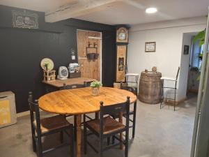 a dining room with a wooden table and a wine barrel at La Grange Aux Mille Feuilles in Castres +10 photos