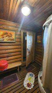 a small bathroom with a bench and a door at Pumpuri in Svente +49 photos