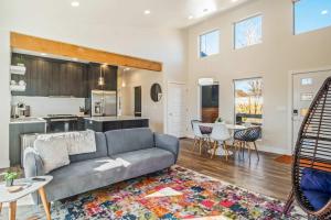 a living room with a couch and a kitchen at Timber & Tin H 2Bed 2Bath w Pool & Rooftop Deck in Kanab