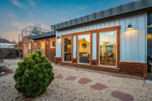 a house with a christmas tree in front of it at Timber & Tin H 2Bed 2Bath w Pool & Rooftop Deck in Kanab