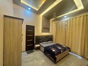 a bedroom with a bed and a cabinet in it at Royal Heritage Lonavla - 7BHK with Turf in Lonavala +49 photos
