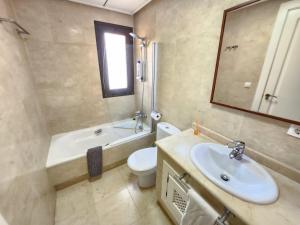 a bathroom with a sink and a toilet and a mirror at RodaGolf Resort Nice Views in San Javier +9 photos