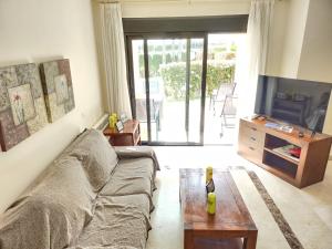 a living room with a couch and a tv at RodaGolf Resort Nice Views in San Javier