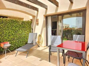 a patio with a red table and chairs at RodaGolf Resort Nice Views in San Javier