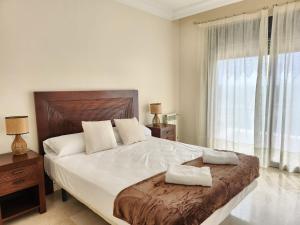 a bedroom with a large bed and a large window at RodaGolf Resort Nice Views in San Javier