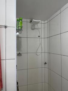 a bathroom with a shower with a shower head at Apartamento enseada in Guarujá