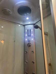 a shower with a glass door and a ceiling at Casa vacanze Castellara in Bevagna +36 photos