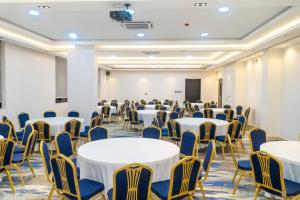 a conference room with tables and chairs and a podium at The Cordis Hotel, Ikeja in Ikeja +38 photos