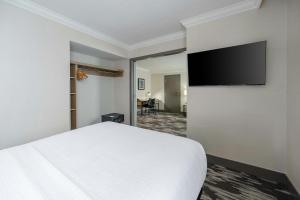 a hotel room with a bed and a flat screen tv at Sandman Signature Mississauga Hotel in Mississauga +43 photos