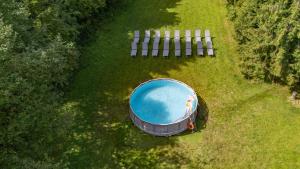 an overhead view of a swimming pool in the grass at Leśna Sielanka domek z jacuzzi w lesie pod Górą Szczebel RELAX I SPORT in Lubień